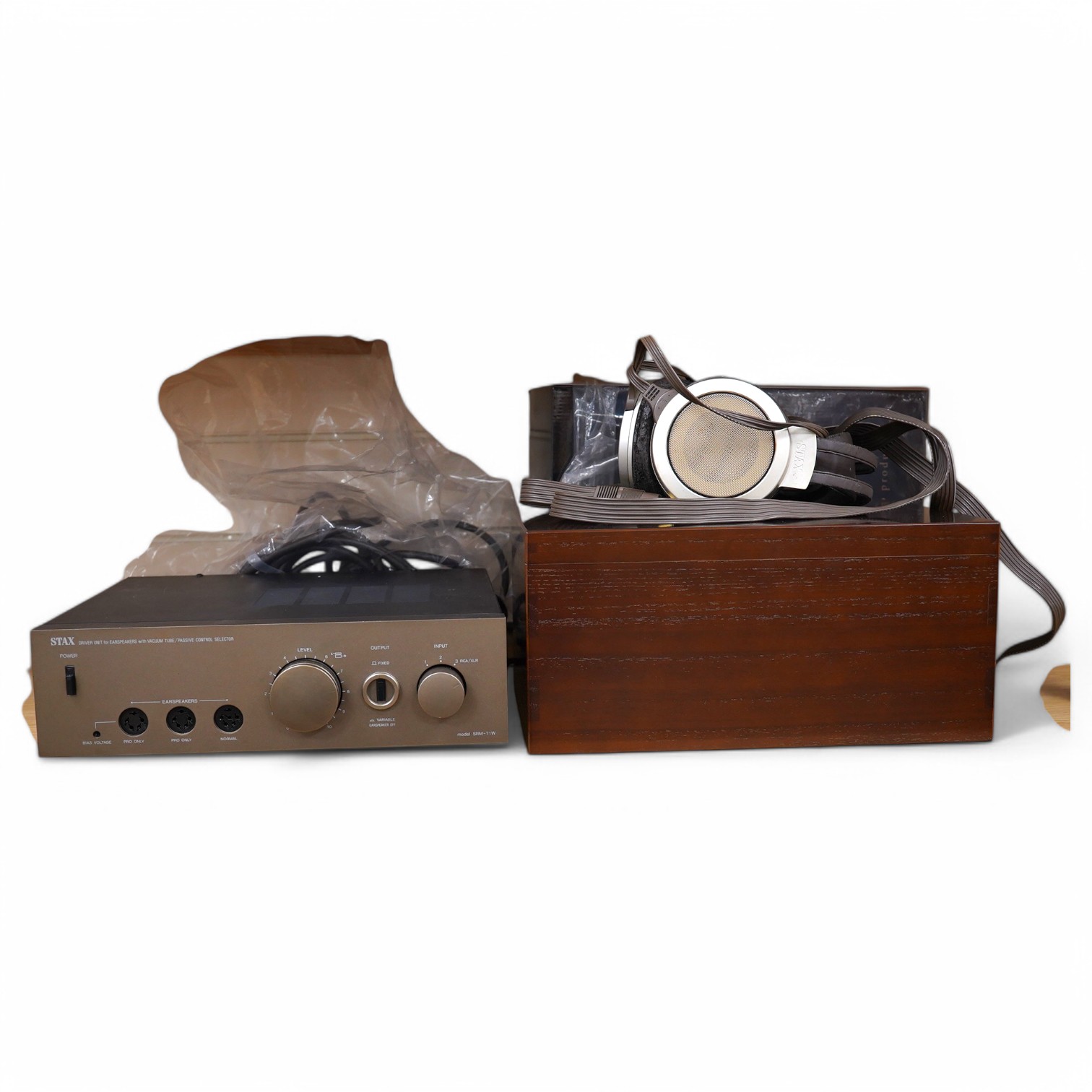 A pair of over-ear Japanese Stax Electrostatic earspeakers, SR-009S, contained within the original wooden box, with outer packaging, owners manual, etc. together with the Stax driver unit for earspeakers with vacuum tube